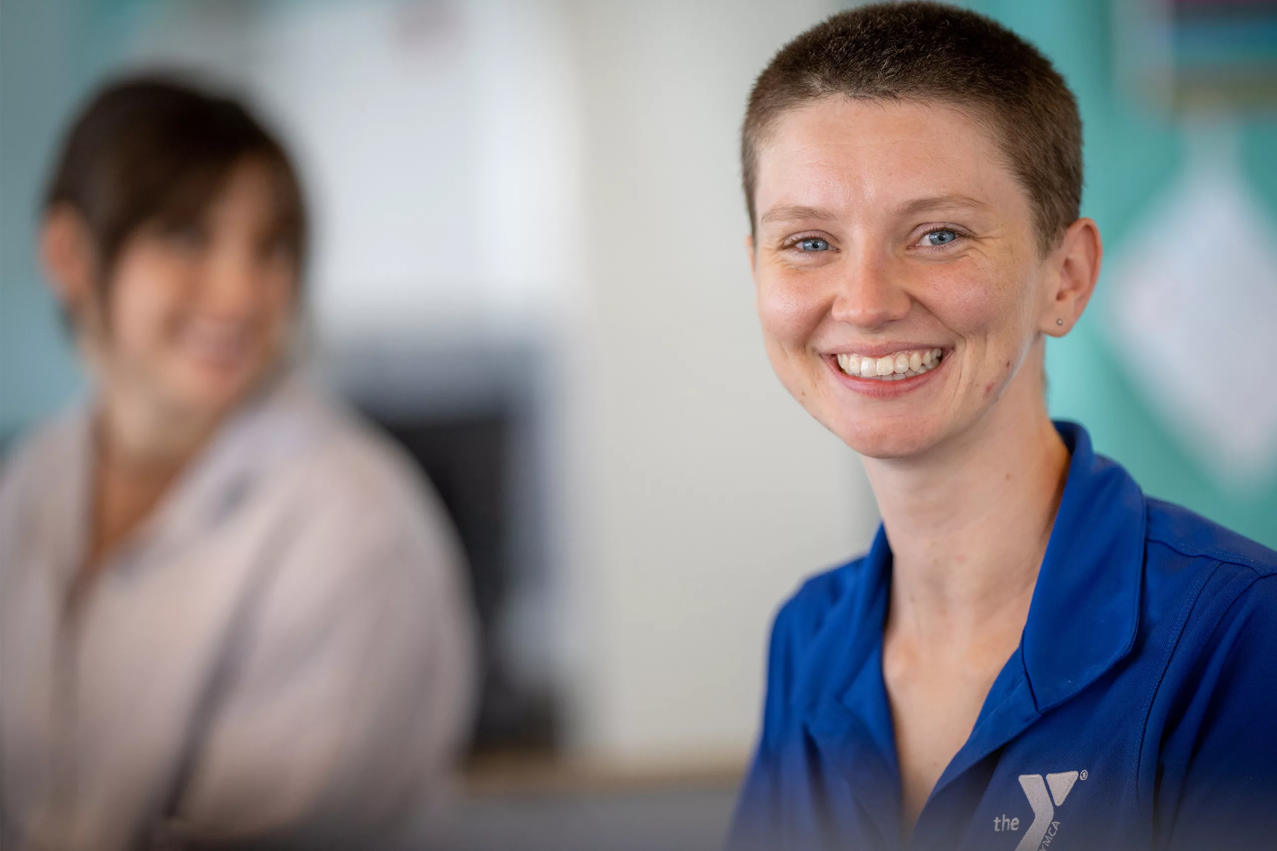 A YMCA staff member smiles and appears welcoming