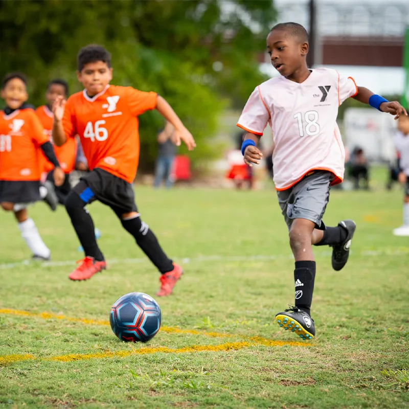 Children play soccer outdoors.