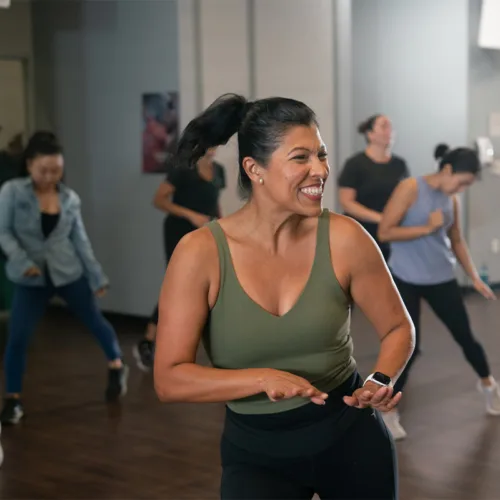 Women dance in a group exercise class