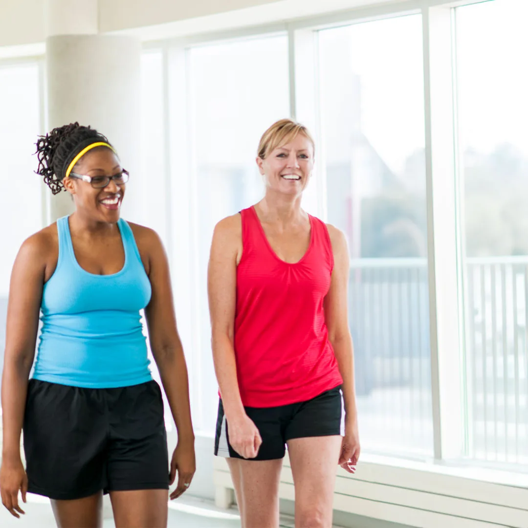 Two women walking indoors