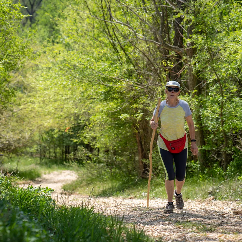 A woman hikes along a nature trail