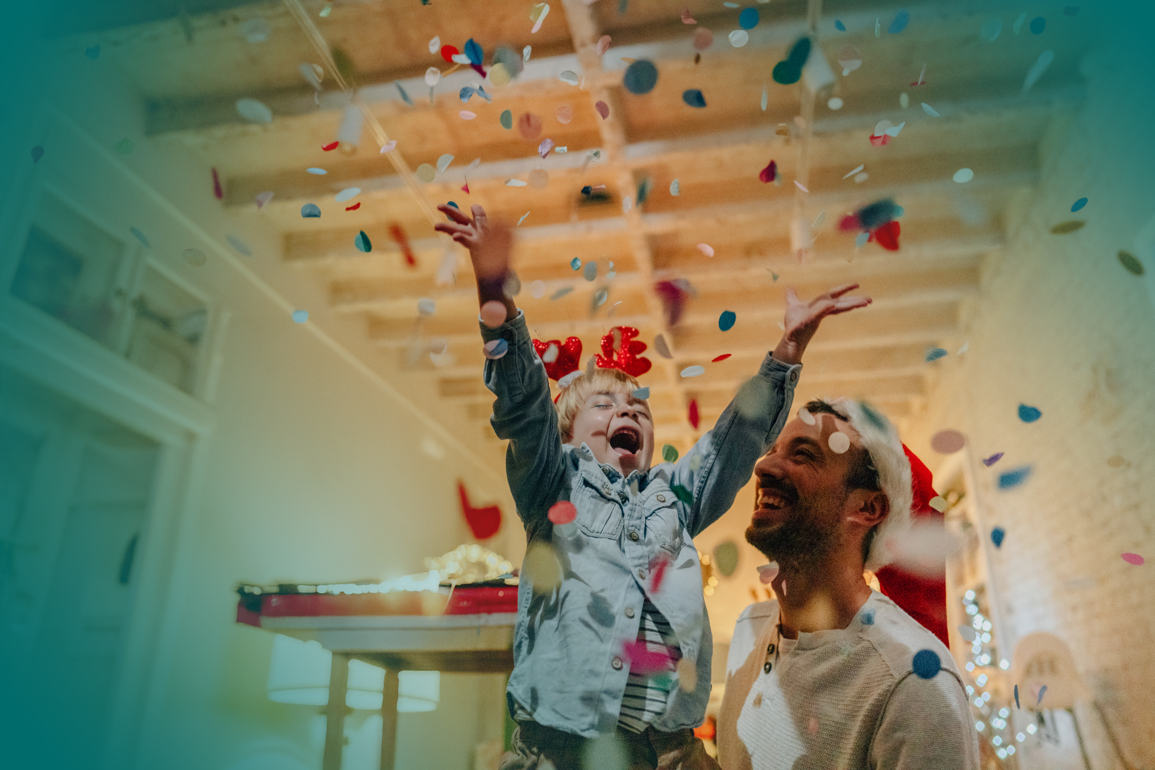 Father and son throwing holiday confetti