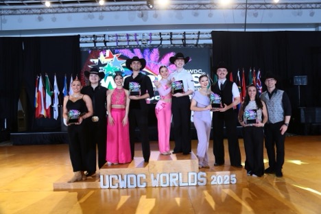 A dance team poses with their trophies