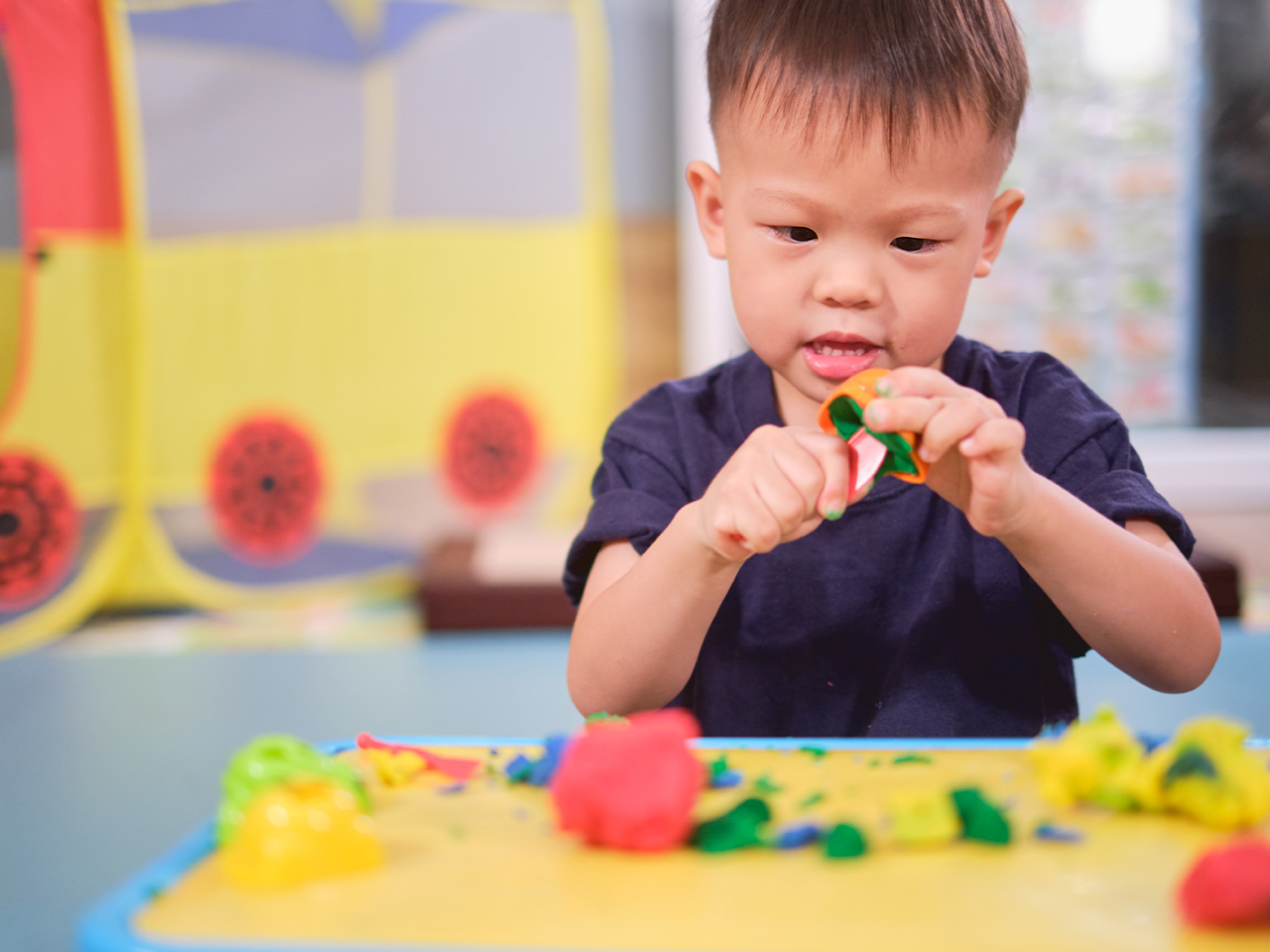 A toddler plays with building toys